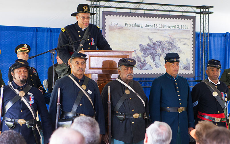Members of the 54th in front of the stage during the stamp dedication ceremony.
