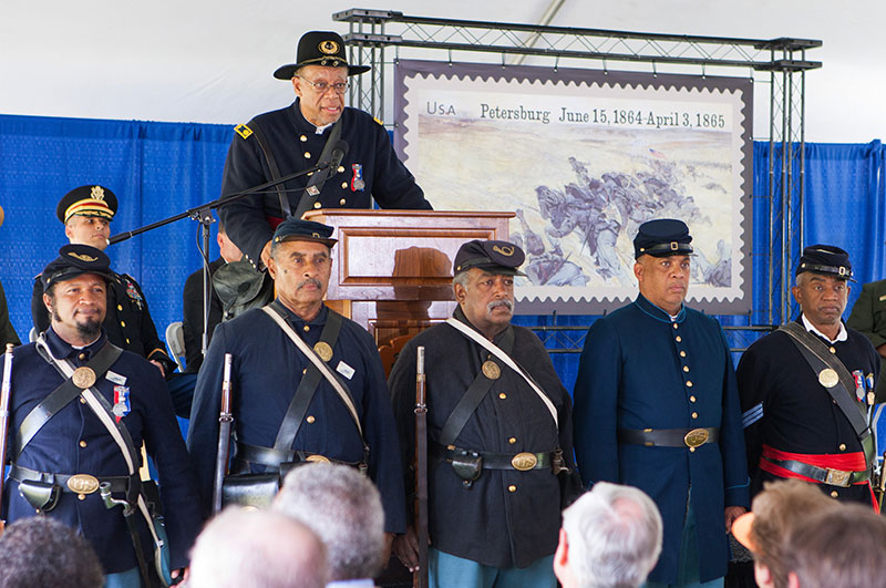 Members of the 54th in front of the stage during the stamp dedication ceremony.